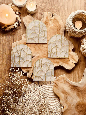 4 white resin coasters with gold 3D design