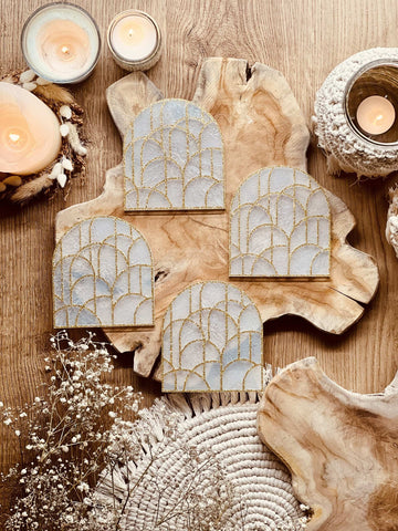 4 white resin coasters with gold 3D design