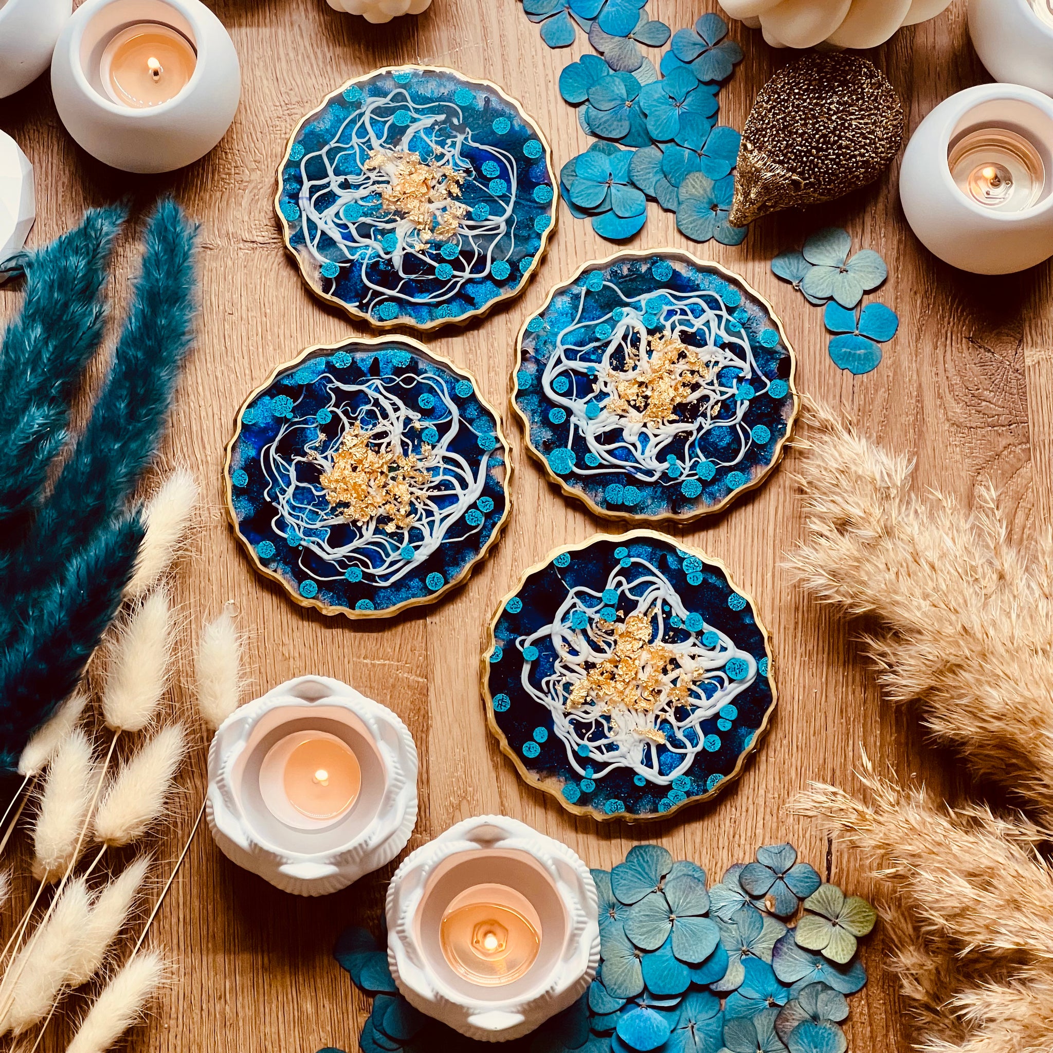 4 resin coasters in blue and white with gold